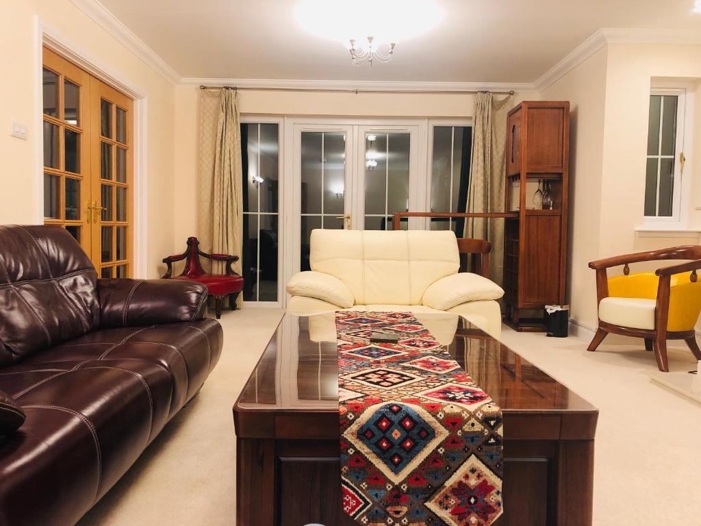 uma sala de estar com um sofá e uma mesa de centro em Taigh d'Luxe em Inverness