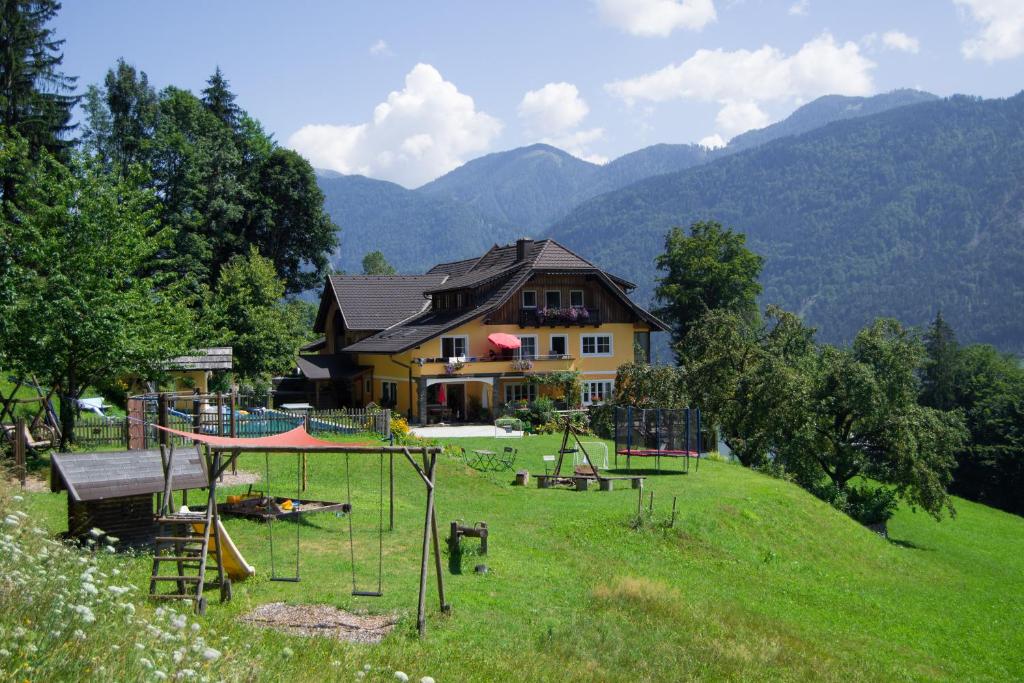 a house with a playground in front of a house at Ferienwohnung Freihof - Nassfeld in Hermagor