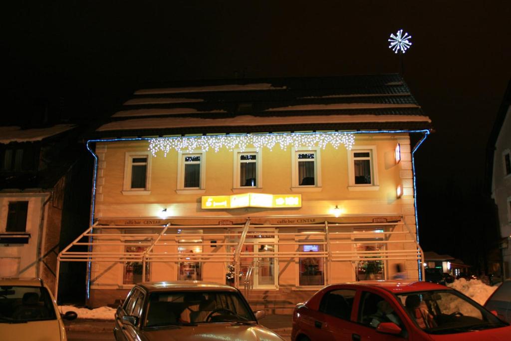 a building with christmas lights on the side of it at Rooms Centar in Delnice