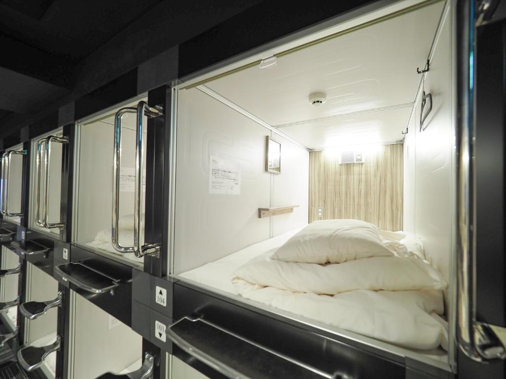 Postel nebo postele na pokoji v ubytování LEO YU Capsule Hotel Nishifunabashi