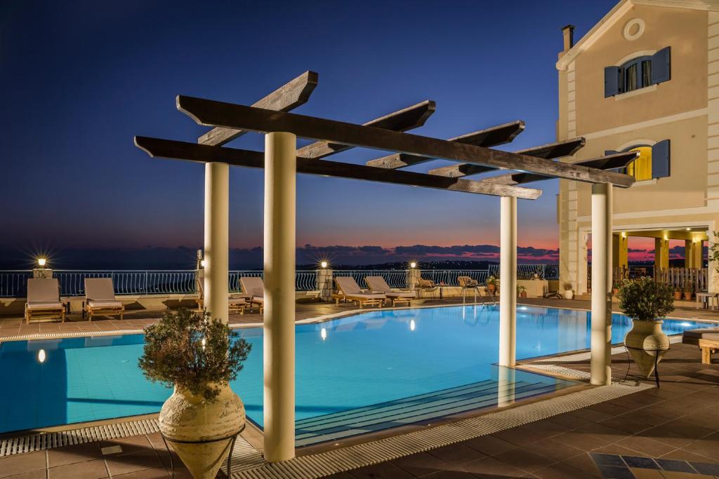 a pool with a pergola on top of a building at Diana Studios in Trapezaki