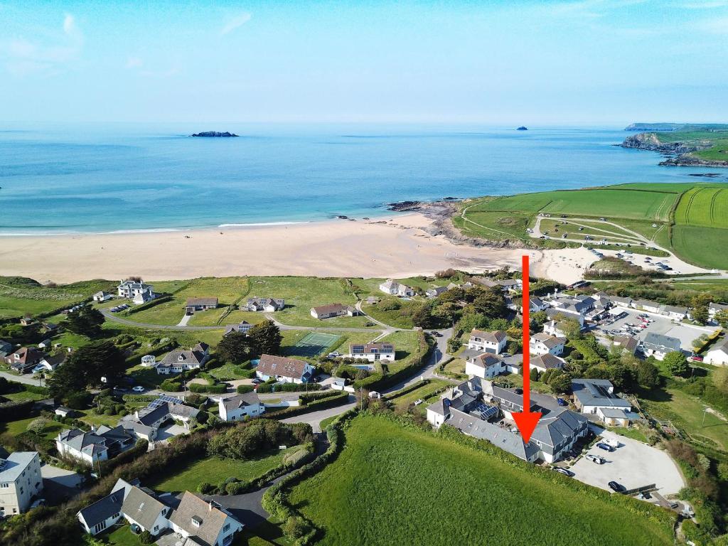 an aerial view of a beach with houses and the ocean at BY THE BEACH Harlyn Bay in St Merryn