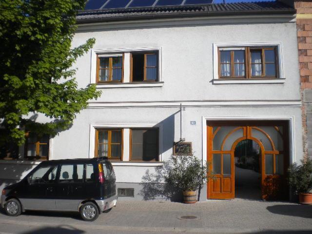 a van parked in front of a white house at Gästehaus Auer Werner in Jois