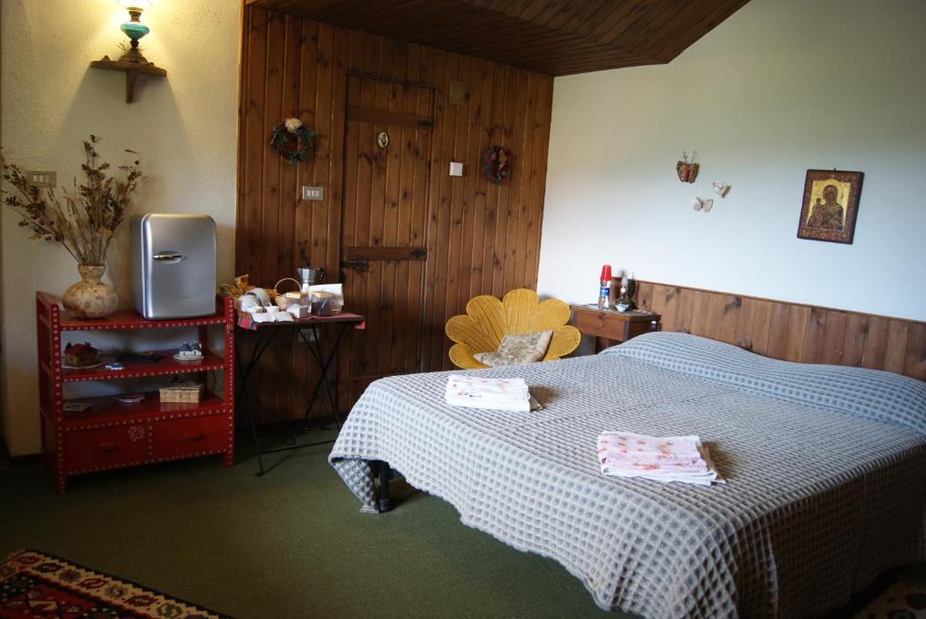 Postel nebo postele na pokoji v ubytování B&B IL QUERCETO