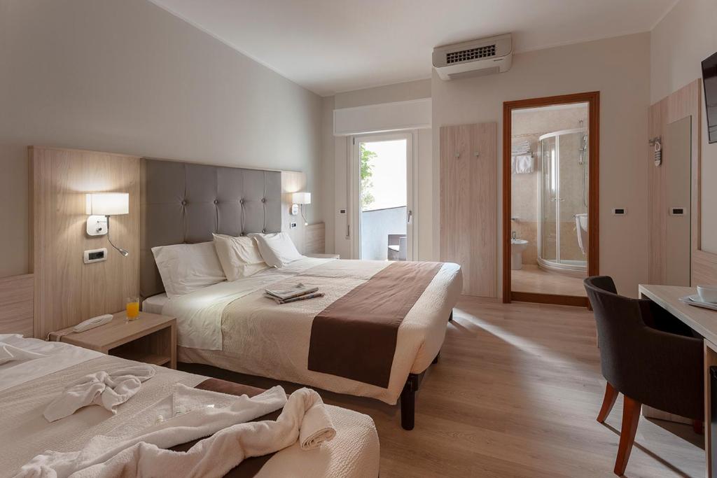 Postel nebo postele na pokoji v ubytování Hotel Montereale