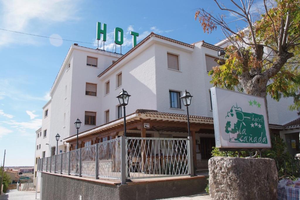 a building with a sign in front of it at La Cañada in Horche