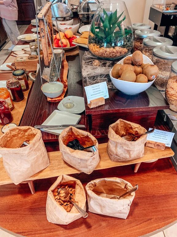 a buffet of food with bags of food on a table at Hotel Marina in Izola
