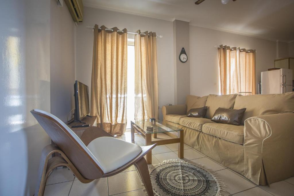 a living room with a couch and a chair at Francis Getaway in Pireaus in Piraeus