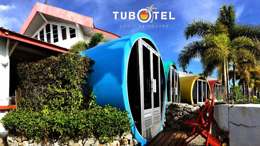 a house with a toilet in front of it at Tubotel in Pantai Cenang