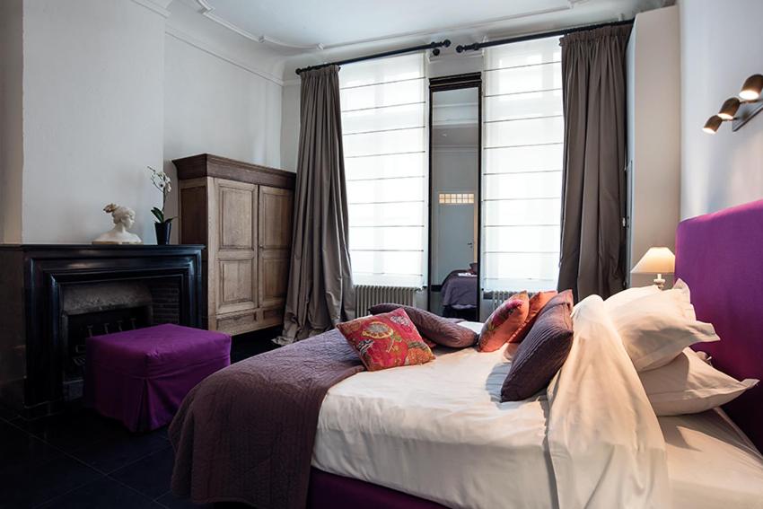 Postel nebo postele na pokoji v ubytování Ganda Rooms & Suites