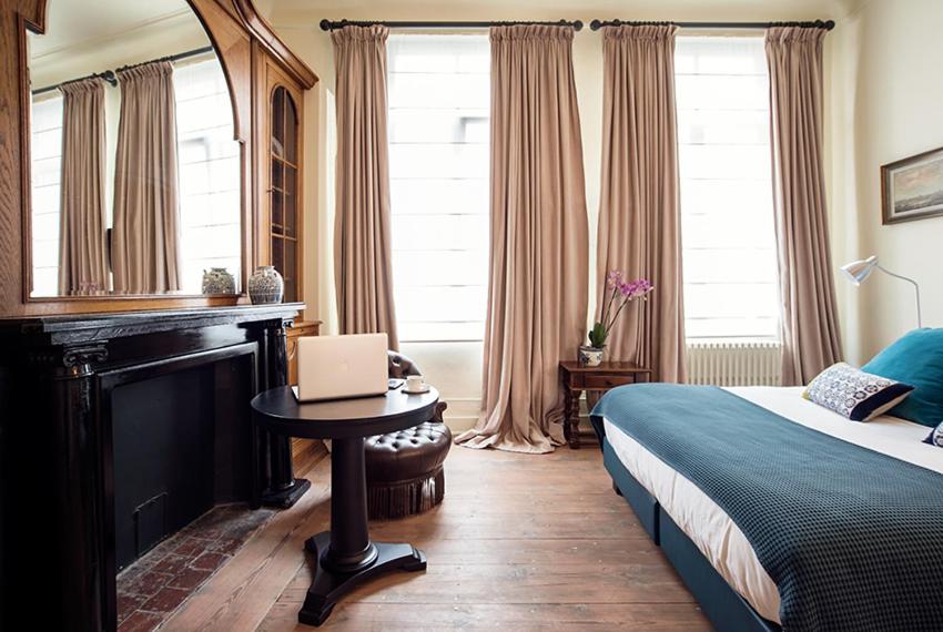 Postel nebo postele na pokoji v ubytování Ganda Rooms & Suites