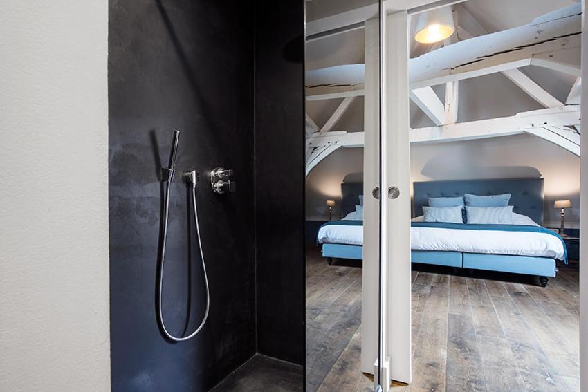Postel nebo postele na pokoji v ubytování Ganda Rooms & Suites
