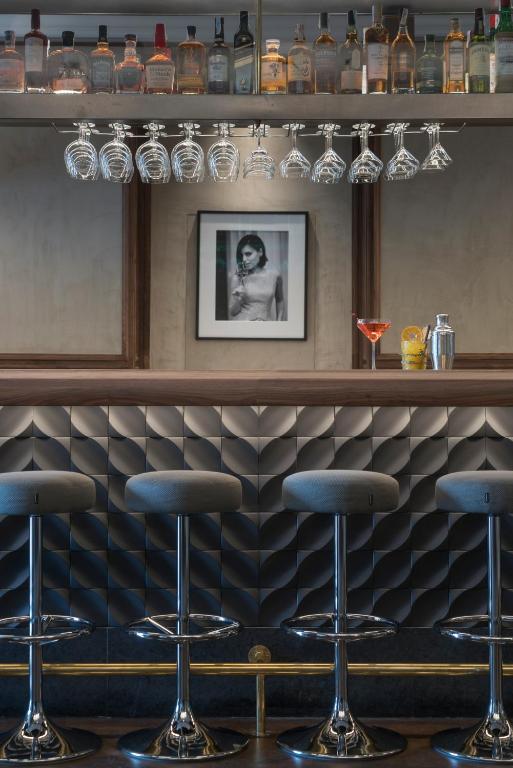 a bar with four bar stools in a room at El Llorenc Parc de la Mar - Adults Only (+16) in Palma de Mallorca