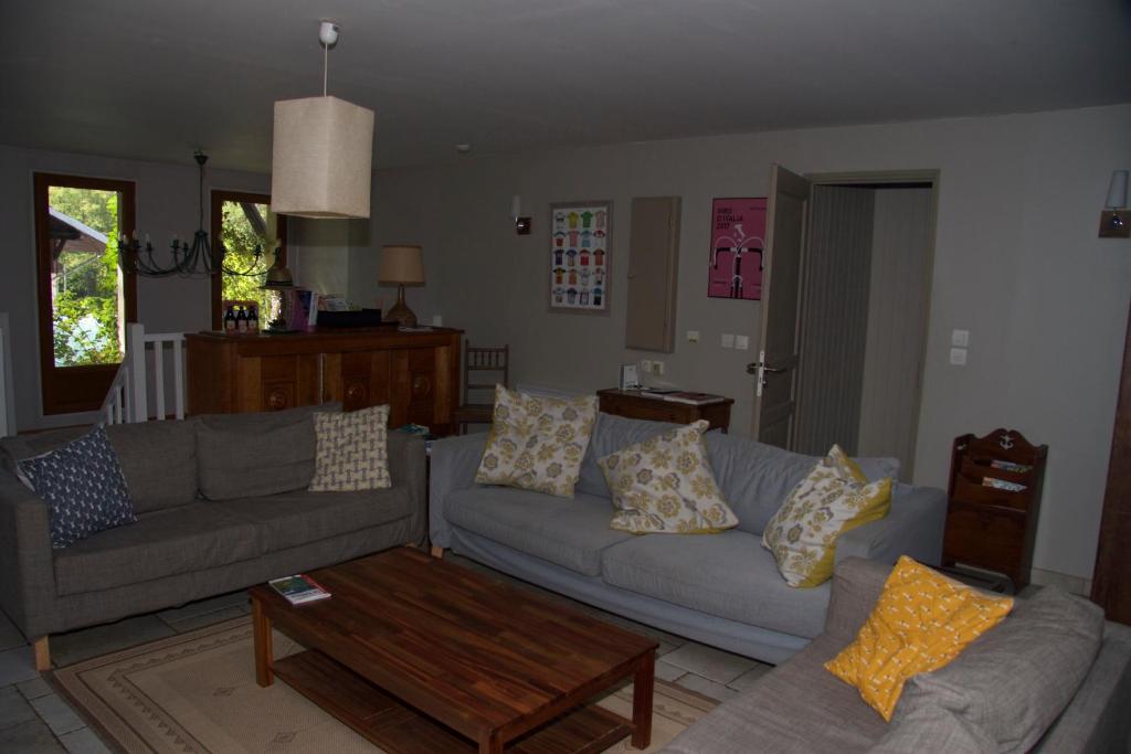 a living room with two couches and a coffee table at Maison Caramel in Landry