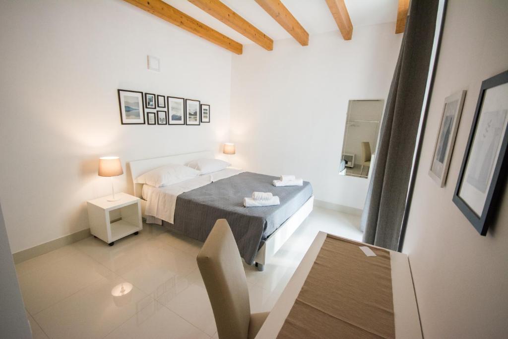 Łóżko lub łóżka w pokoju w obiekcie Palazzo di Fazio Suites