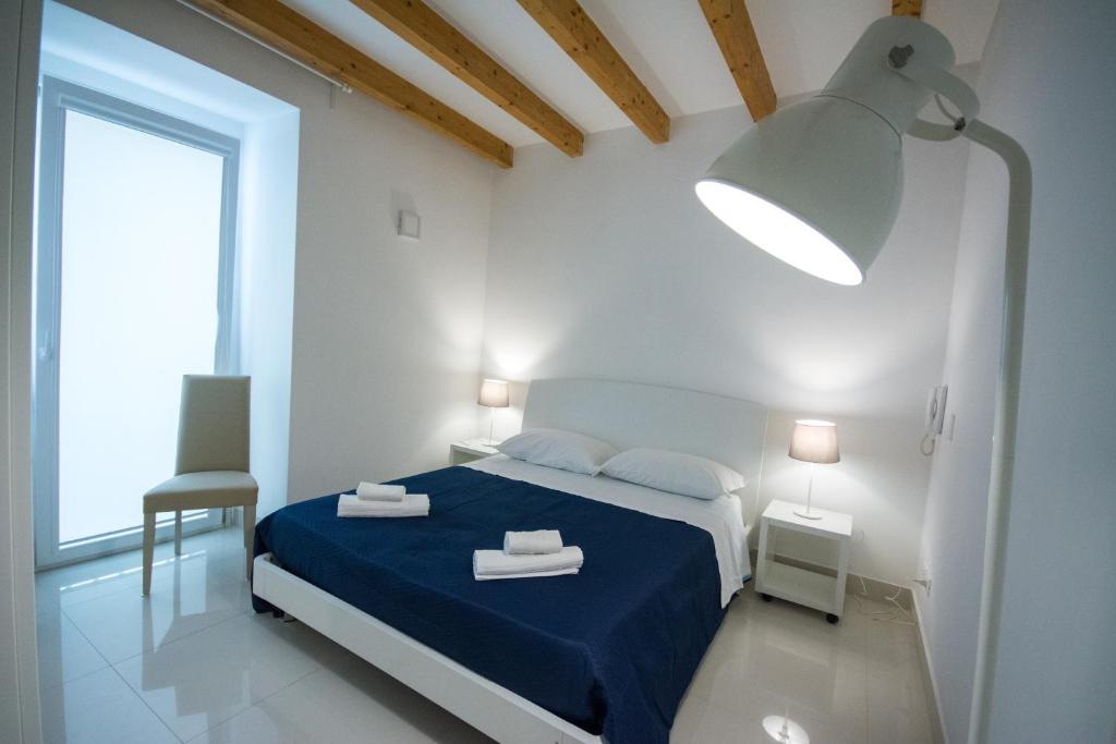 Łóżko lub łóżka w pokoju w obiekcie Palazzo di Fazio Suites