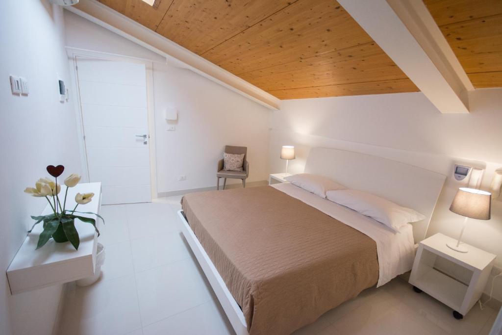 Łóżko lub łóżka w pokoju w obiekcie Palazzo di Fazio Suites