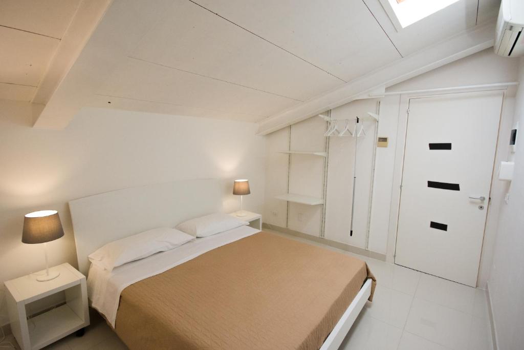 Łóżko lub łóżka w pokoju w obiekcie Palazzo di Fazio Suites