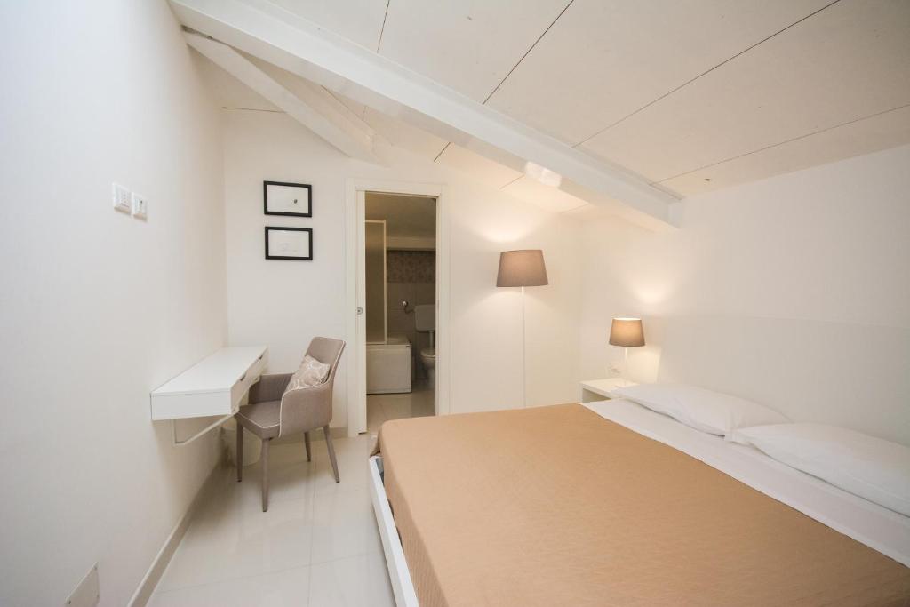 Łóżko lub łóżka w pokoju w obiekcie Palazzo di Fazio Suites