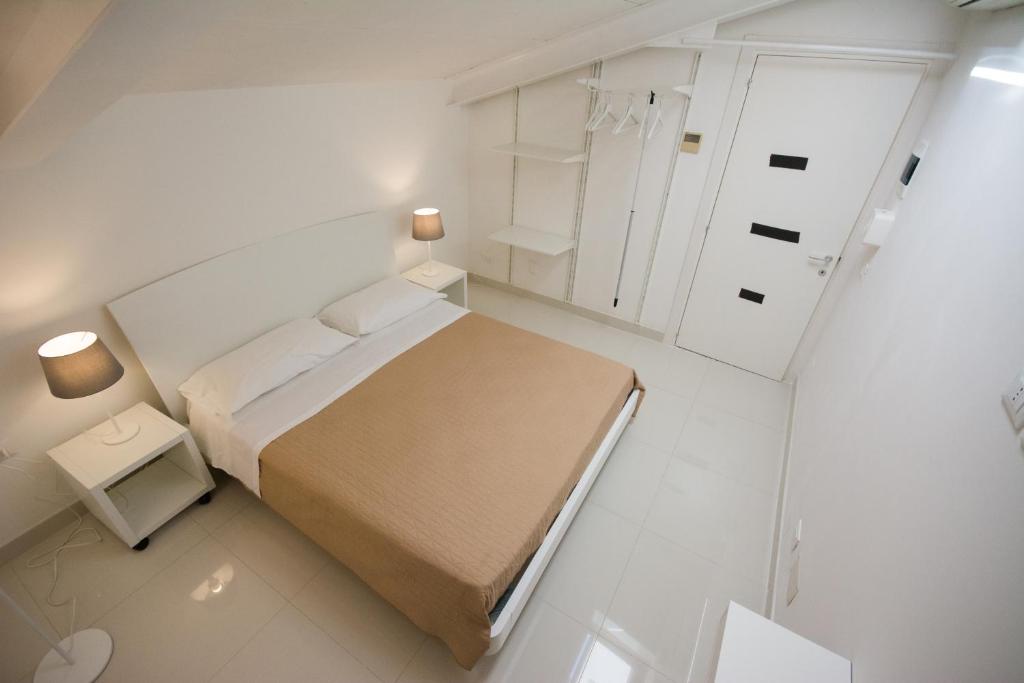 Łóżko lub łóżka w pokoju w obiekcie Palazzo di Fazio Suites