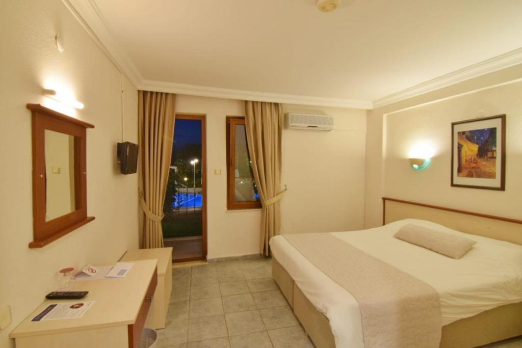 A bed or beds in a room at Olympos Hotel - Adults Only