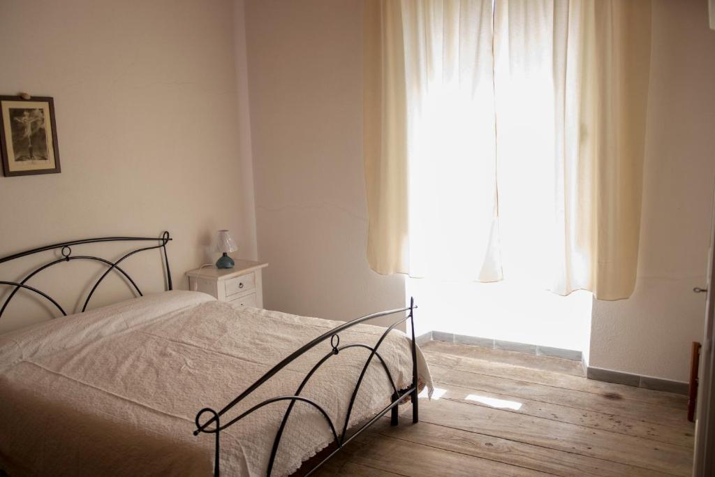 a bedroom with a bed and a window at Casa Cortes in Desulo