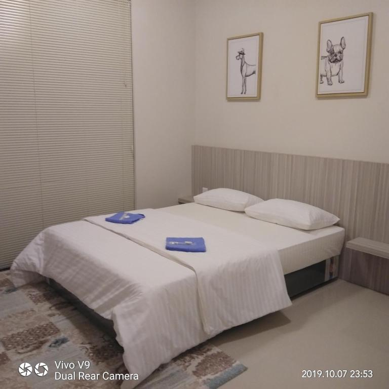 a bedroom with a bed with two blue plates on it at SleepRest @ The Home Shoutlink in Nagoya