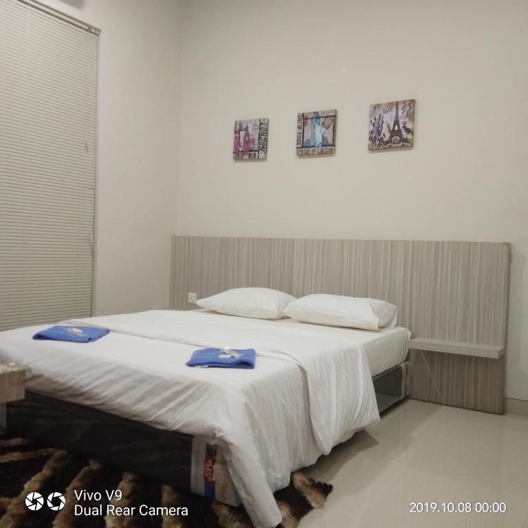 a bedroom with a large bed with towels on it at SleepRest @ The Home Shoutlink in Nagoya