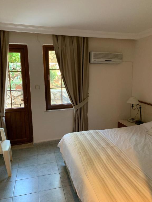 A bed or beds in a room at Olympos Hotel - Adults Only