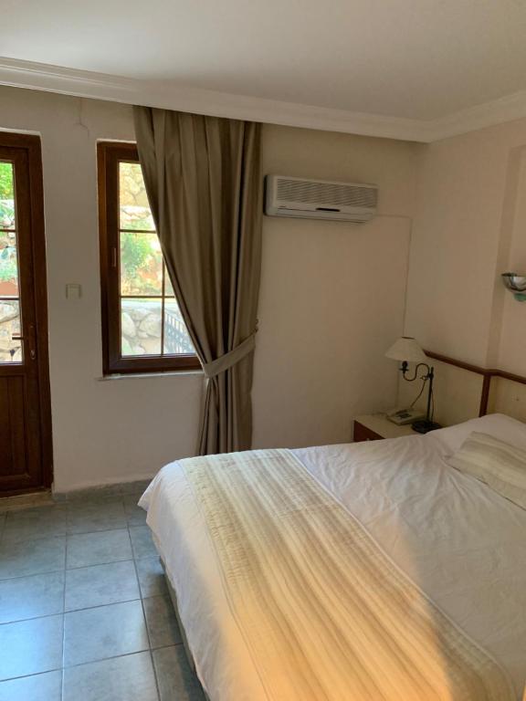 A bed or beds in a room at Olympos Hotel - Adults Only