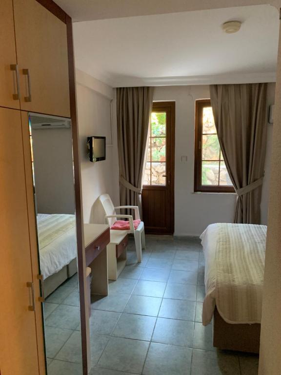 A bed or beds in a room at Olympos Hotel - Adults Only