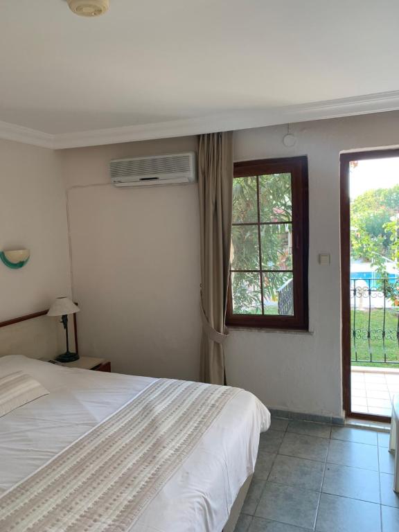 A bed or beds in a room at Olympos Hotel - Adults Only
