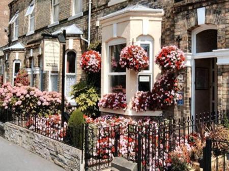 a house with flowers on the side of it at Chelmsford Place Guest House in York