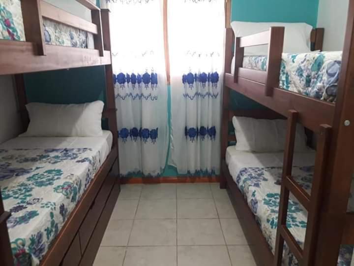 a room with two bunk beds and a window at LA CABAÑA in Termas de Río Hondo