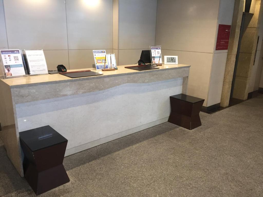 a counter in a building with signs on it at HOTEL MYSTAYS Kamata in Tokyo