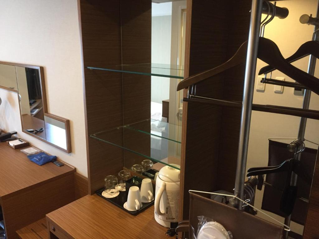 a bathroom with a glass shelf in a room at HOTEL MYSTAYS Kamata in Tokyo