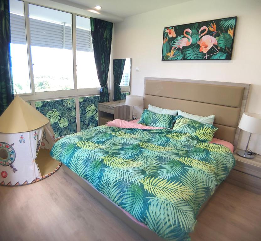a bedroom with a bed with a colorful comforter at LEGOLAND - 1-8 Pax Lego themed house with Superhero, Pirates & Forest at Puteri Harbour in Johor Bahru