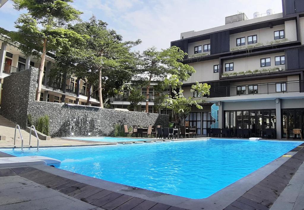 a large blue swimming pool in front of a building at Grand Cordela Hotel AS Putra Kuningan in Kuningan