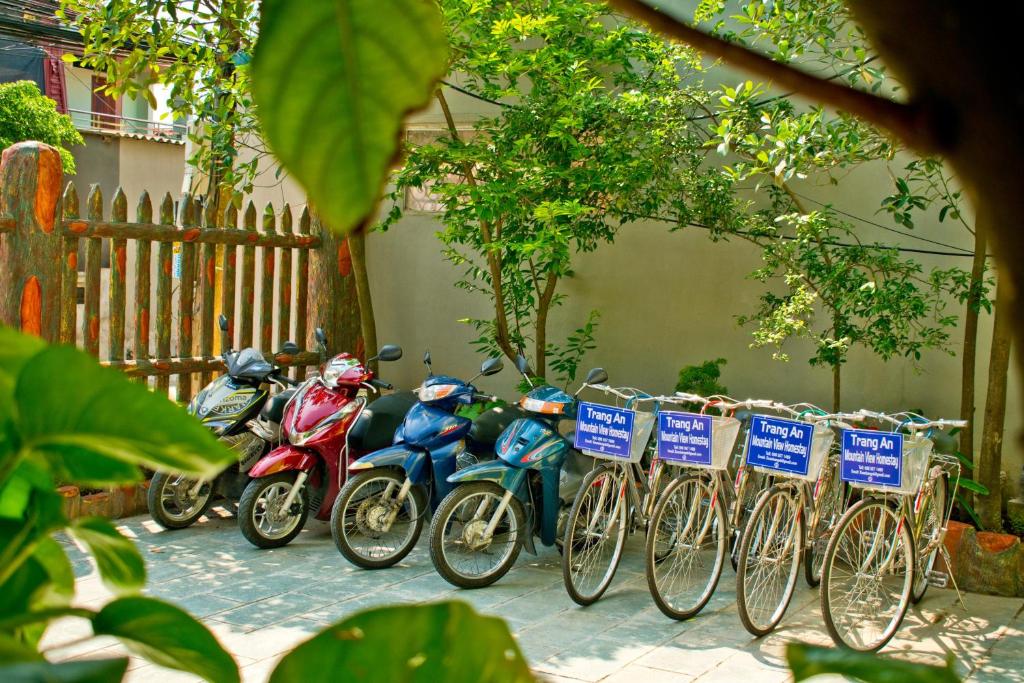 a row of bikes parked next to a fence at Trang An Mountain View Homestay in Ninh Binh