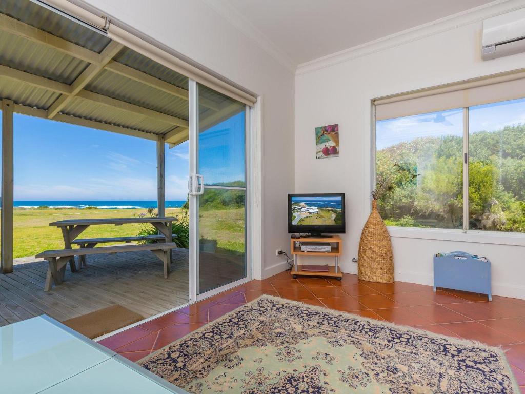 a living room with a view of the ocean at Amhurst Cottage in Port Fairy