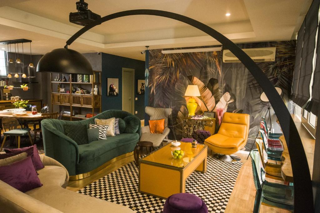 a living room filled with lots of furniture at Vanilla Sky Boutique Hostel in Tirana