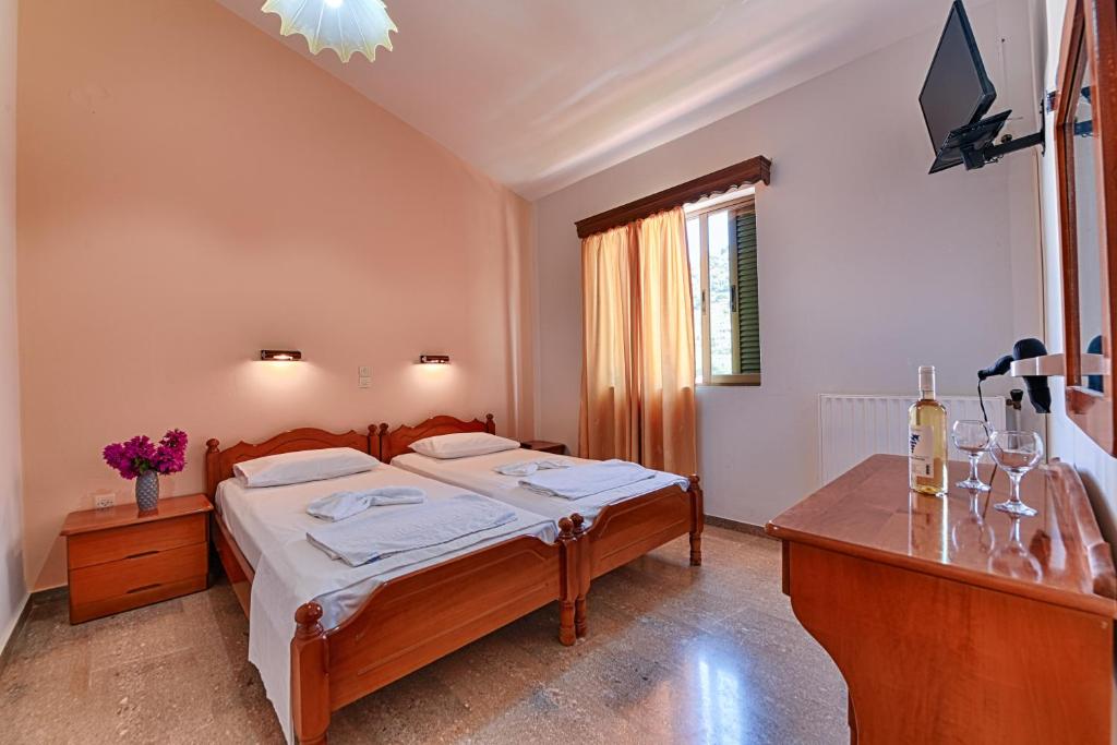 Postel nebo postele na pokoji v ubytování Ionis Hotel