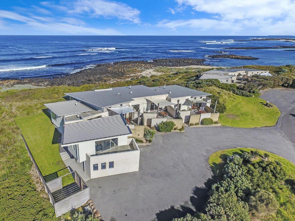 an aerial view of a house with the ocean at Hearns Beachside Villa 4 in Port Fairy