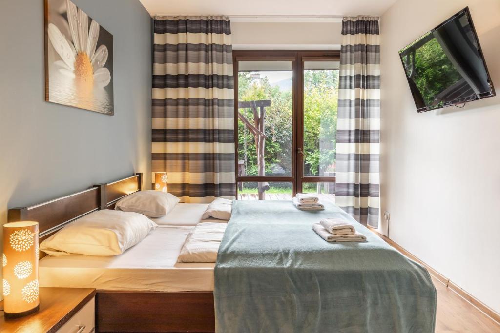 Posteľ alebo postele v izbe v ubytovaní Apartamenty Oaza Deluxe Zakopane