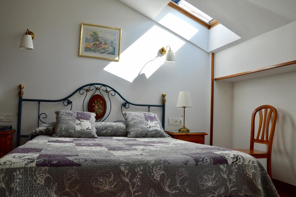 a bedroom with a bed and a skylight at Hotel Alameda in Zarautz