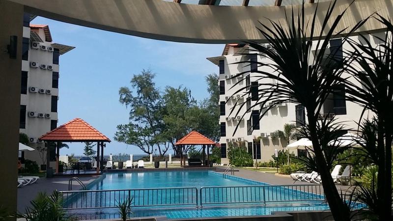 a large swimming pool in front of a building at Samsuria Beach Resort & Residence in Cherating