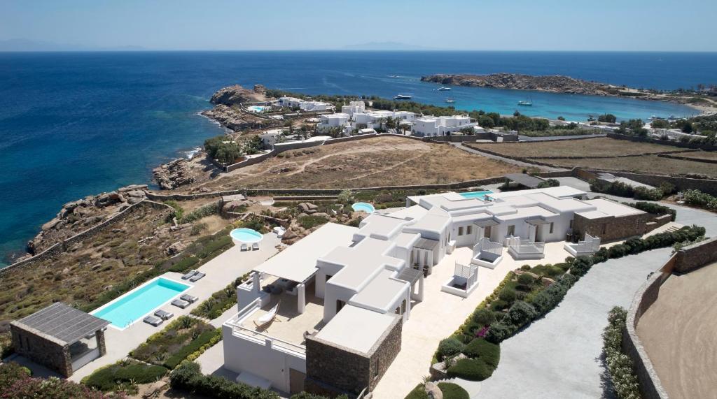 an aerial view of a large white house with the ocean at ABSOLUTE PARADISE in Paradise Beach