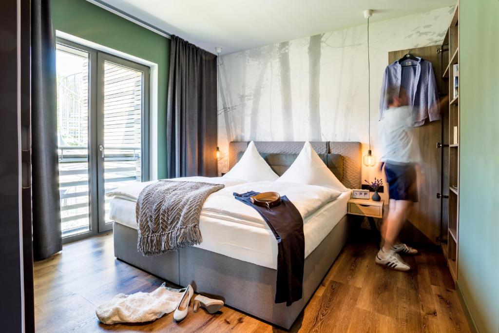 Postel nebo postele na pokoji v ubytování EchtZeit - Dein Hotelquartier