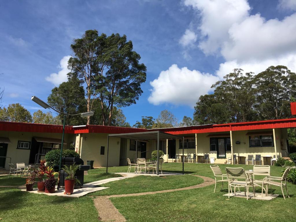 a building with chairs and tables in the yard at Major Innes Motel in Port Macquarie