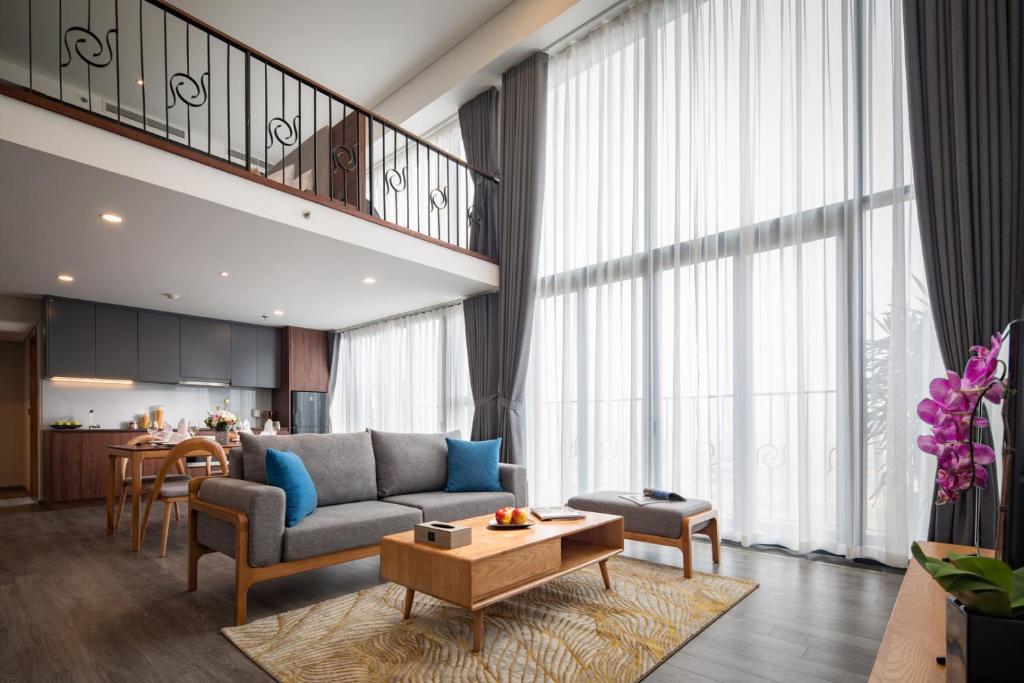 a living room with a couch and a table at PentStudio West Lake Hanoi in Hanoi